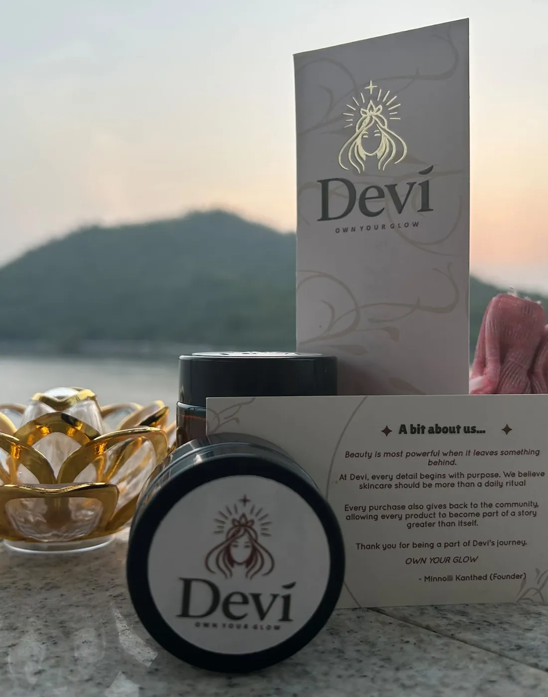 Devī jar with the founder’s note card and a lotus holder